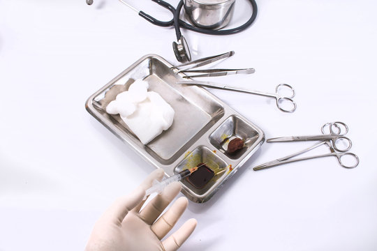 hand and syringe in dressing wound set on bright background