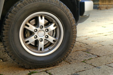 Car wheel on a pavement close up