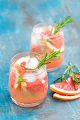 Grapefruit and rosemary gin cocktail, refreshing drink with ice