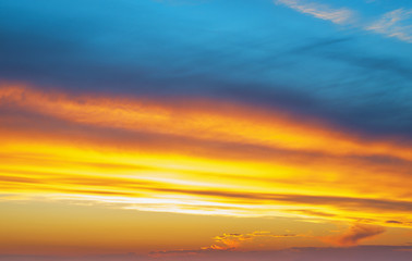 Blue and orange colorful beautiful cloudy sunset background.