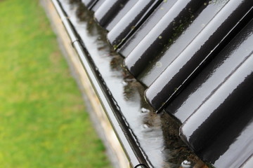 An image of a drain with raindrops