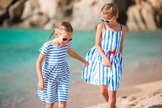 Adorable little girls during summer vacation. Kids enjoy their travel in Greece