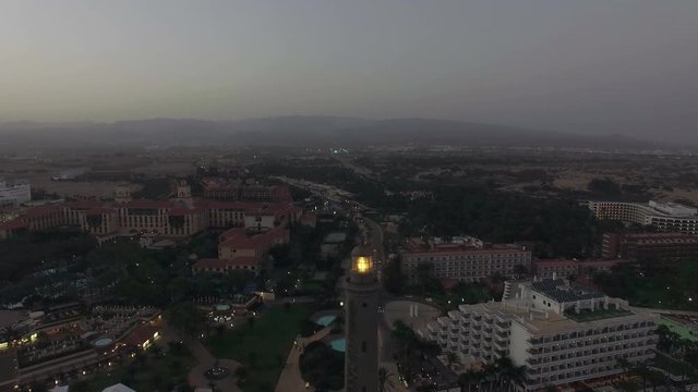 Aerial view of lit Maspalomas Lighthouse and tourist resort in the dusk, Gran Canaria