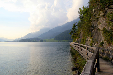 Travel to Sankt-Wolfgang, Austria. The road near to lake with the mountains on the background in the sunny day.