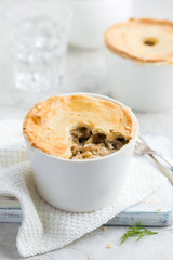 chicken and mushrooms pot pie in white ramekin