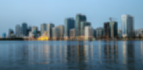 Obraz premium Defocused blurred background Night view of Sharjah skyscrapers