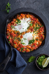 baked eggs with spicy beans and tomato sauce.