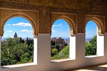 Stone arches in the world-famous Alhambra in Granada with beautiful views of the fortress and...