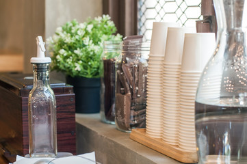 Coffee bar equipment straw box water and paper grass.