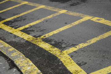 Asphalt street with narrow and tight yellow lines