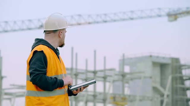 construction engineer at the construction site using the tablet