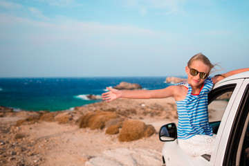 Little girl on vacation travel by car background beautiful landscape