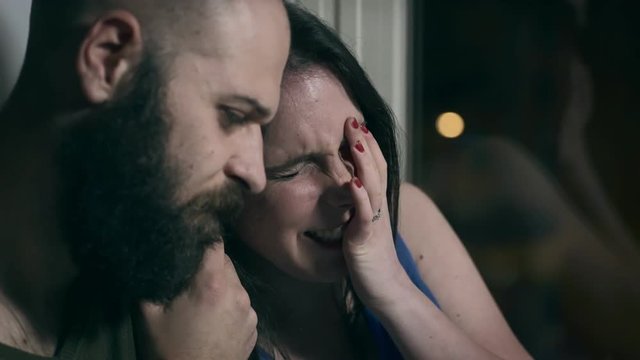 bald man comforting his desperate girlfriend crying 