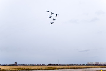 Air show in the sky above the Krasnodar airport flight school. Airshow in honor of Defender of the...