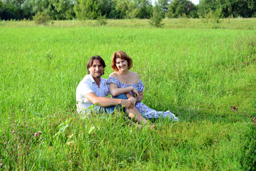 Fototapeta premium Man and woman on meadow in summer