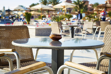 Empty table with chairs at restaurant outside in hotel