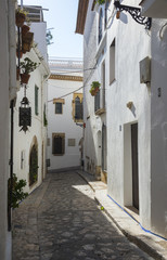 Narrow medieval street in Old Sitges town, Barcelona, Spain