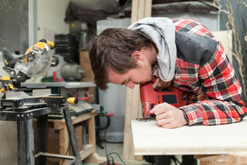 Young carpenter in his workshop