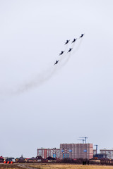 Air show in the sky above the Krasnodar airport flight school. Airshow in honor of Defender of the Fatherland. MiG-29 in the sky.