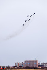 Air show in the sky above the Krasnodar airport flight school. Airshow in honor of Defender of the Fatherland. MiG-29 in the sky.