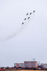 Air show in the sky above the Krasnodar airport flight school. Airshow in honor of Defender of the Fatherland. MiG-29 in the sky.