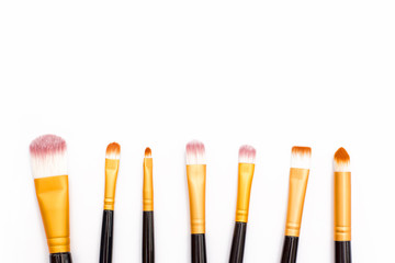 makeup brush lying casually on white background
