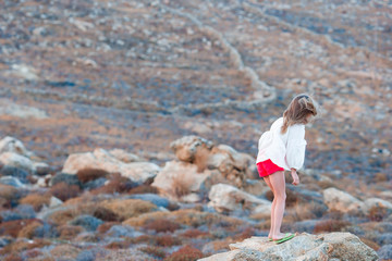 Adorable little girl in Greece walking in wild nature