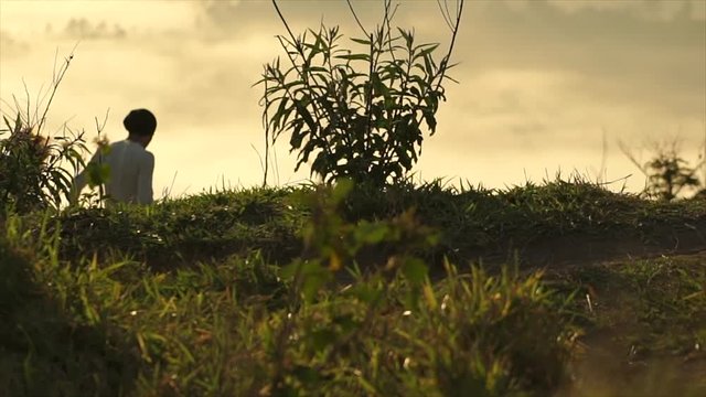 Young couple enjoying the sunset in the meadow
