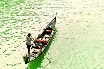 Gondola punted by a gondolier on the Grand Canal in Venice. 