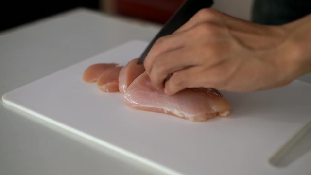  prepare cooking by chopping chicken breast