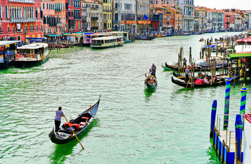 Fototapeta na wymiar View of the Gondolas rowing on the Grand Canal in Venice