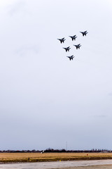 Air show in the sky above the Krasnodar airport flight school. Airshow in honor of Defender of the Fatherland. MiG-29 in the sky.