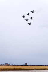 Air show in the sky above the Krasnodar airport flight school. Airshow in honor of Defender of the Fatherland. MiG-29 in the sky.
