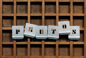 Word PHOTOS with stencils on old typefaces wooden container.