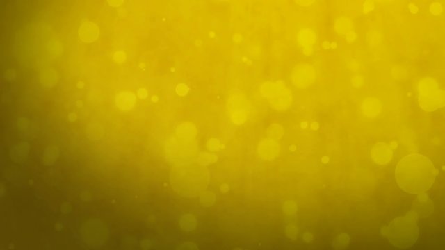 Abstract golden yellow background with floating particles. Seamlessly loopable animation.