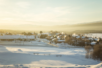 Fototapeta na wymiar A beautiful morning panorama of a small Norwegian town during sunrise with a flares and warm look