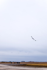 Air show in the sky above the Krasnodar airport flight school. Airshow in honor of Defender of the Fatherland. MiG-29 in the sky.