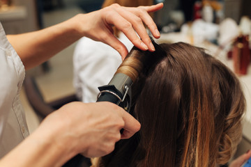 master in a beauty salon girl doing hairstyle