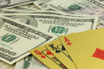 playing cards and hundred-dollar bills closeup.