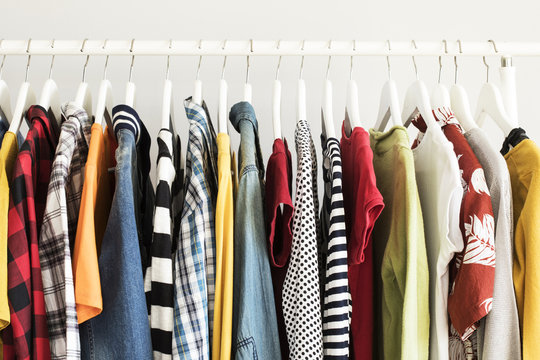 Collection of clothes hanging on rack