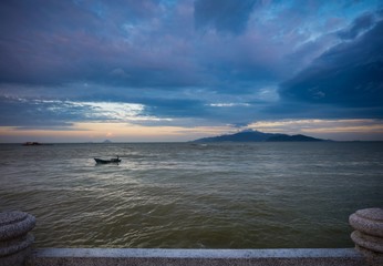A colourful cloudy evening sky over the south china sea and coastal islands in Nha Trang Vietnam.