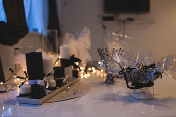 Holiday table decoration with white candles and bulb garland