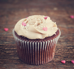 Chocolate cupcakes decorated with cream rose hearts toning