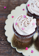 Chocolate cupcakes decorated with cream rose hearts