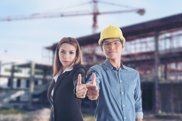 Engineers and business women show thumbs up with the Building Under Construction background.