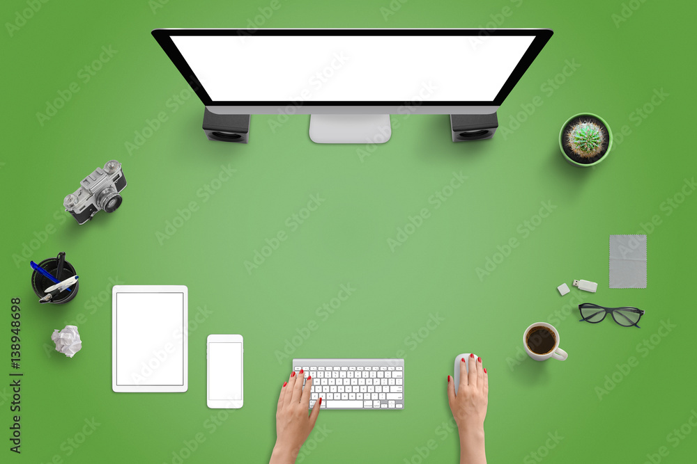 Aufkleber Top view of studio desk with modern devices. Computer display, tablet and mobile phone. Green desk with free space for text.