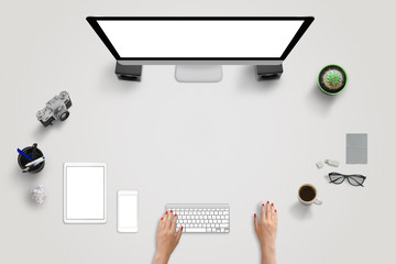 Creative work desk scene with devices. Woman work on computer. Isolated, white, blank screens for...