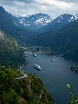 Elevated view of ships docked in harbour below remote mountains © Ben R