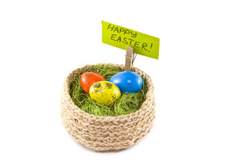 Easter eggs in a basket.Painted Quail eggs. Knitted basket of jute, sisal green.