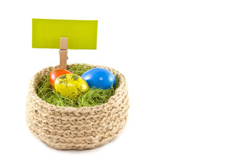 Easter eggs in a basket.Painted Quail eggs. Knitted basket of jute, sisal green.
